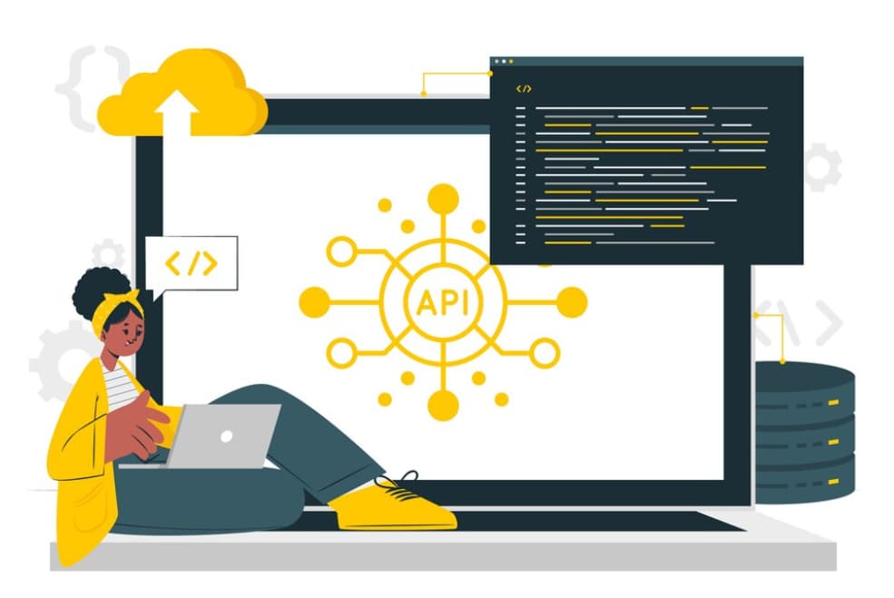 A developer works on a laptop with API and code graphics on the screen