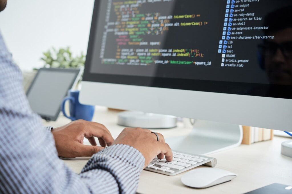 Man writes code on a computer