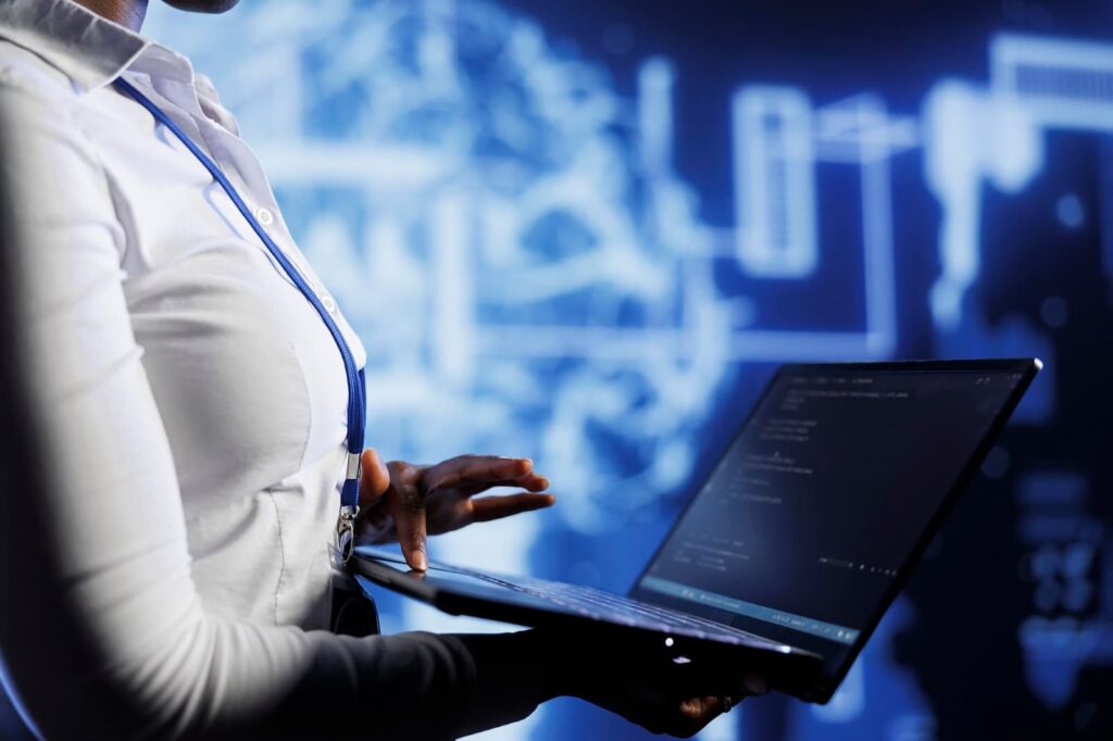 Woman holding laptop with code