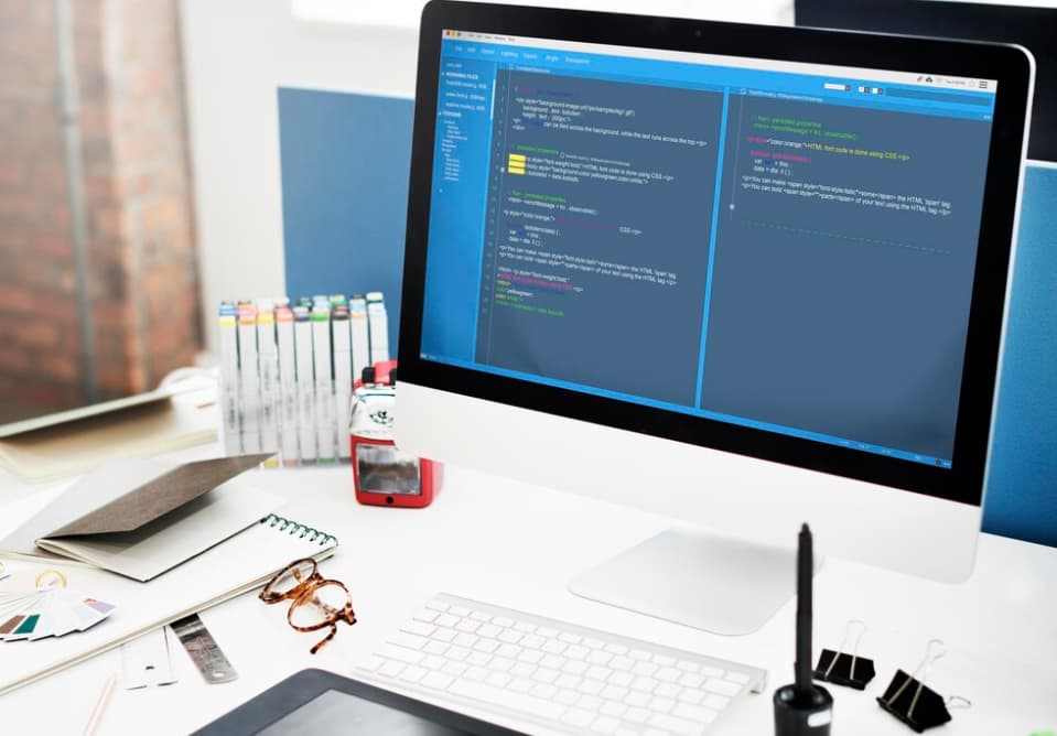 A desktop computer displaying code on the screen